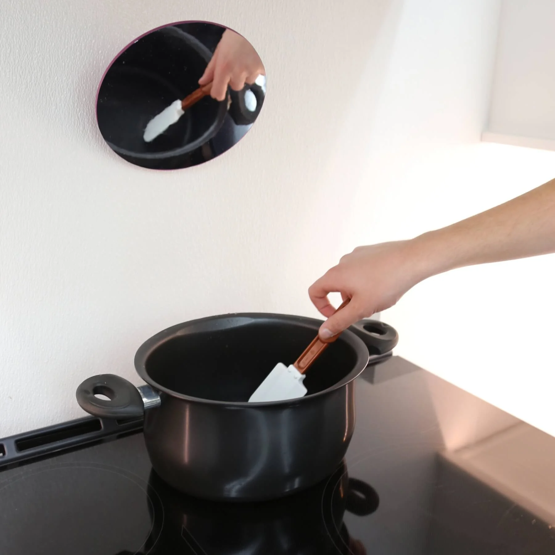 Adjustable mirror in use near back of stove