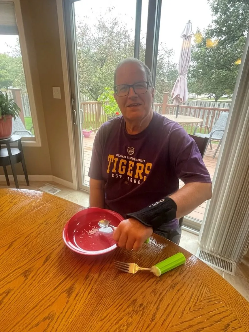 Ken using a utensil assist