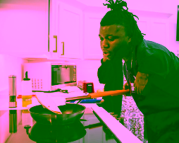 Person using long handled cooking assist