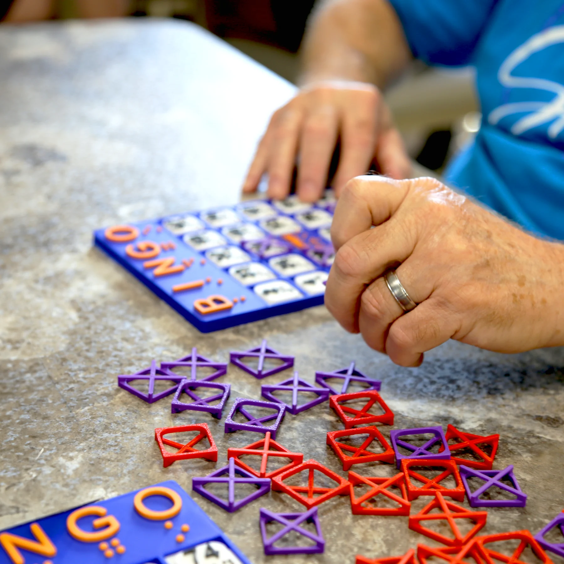 Hands reading bingo board
