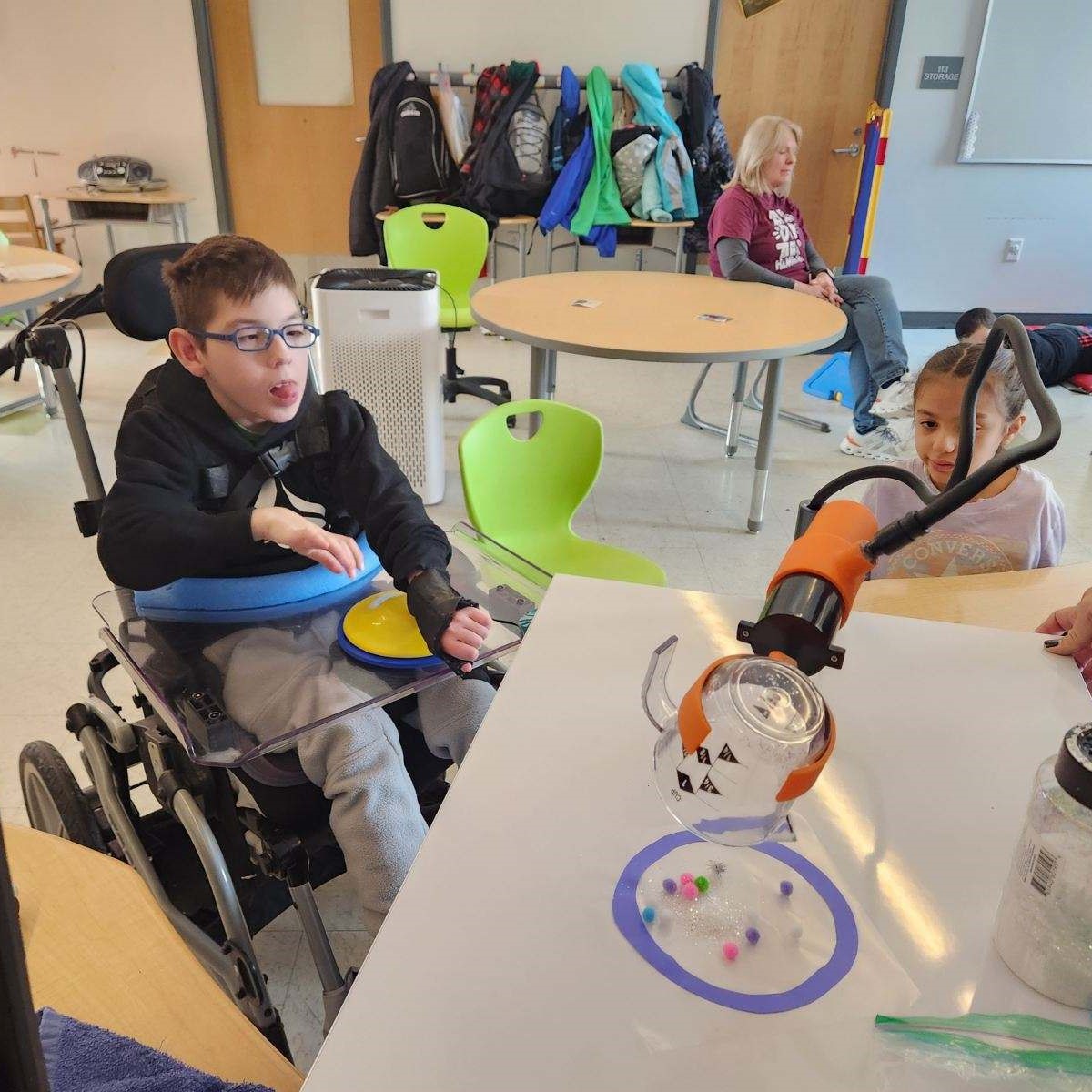 Classroom using Adapted Pouring Device to pour cup