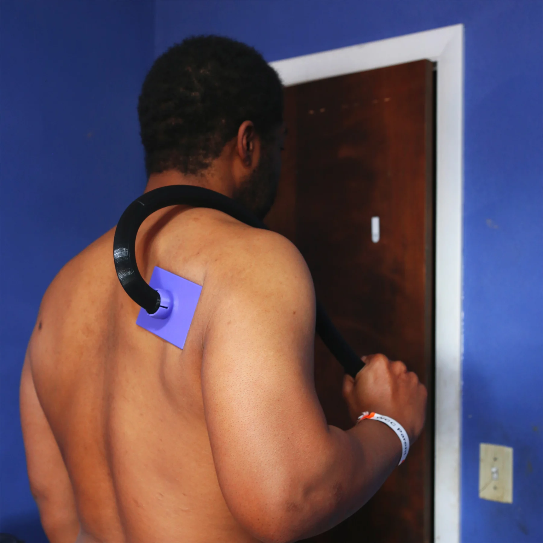 Man using Medical Patch Applicator on his back