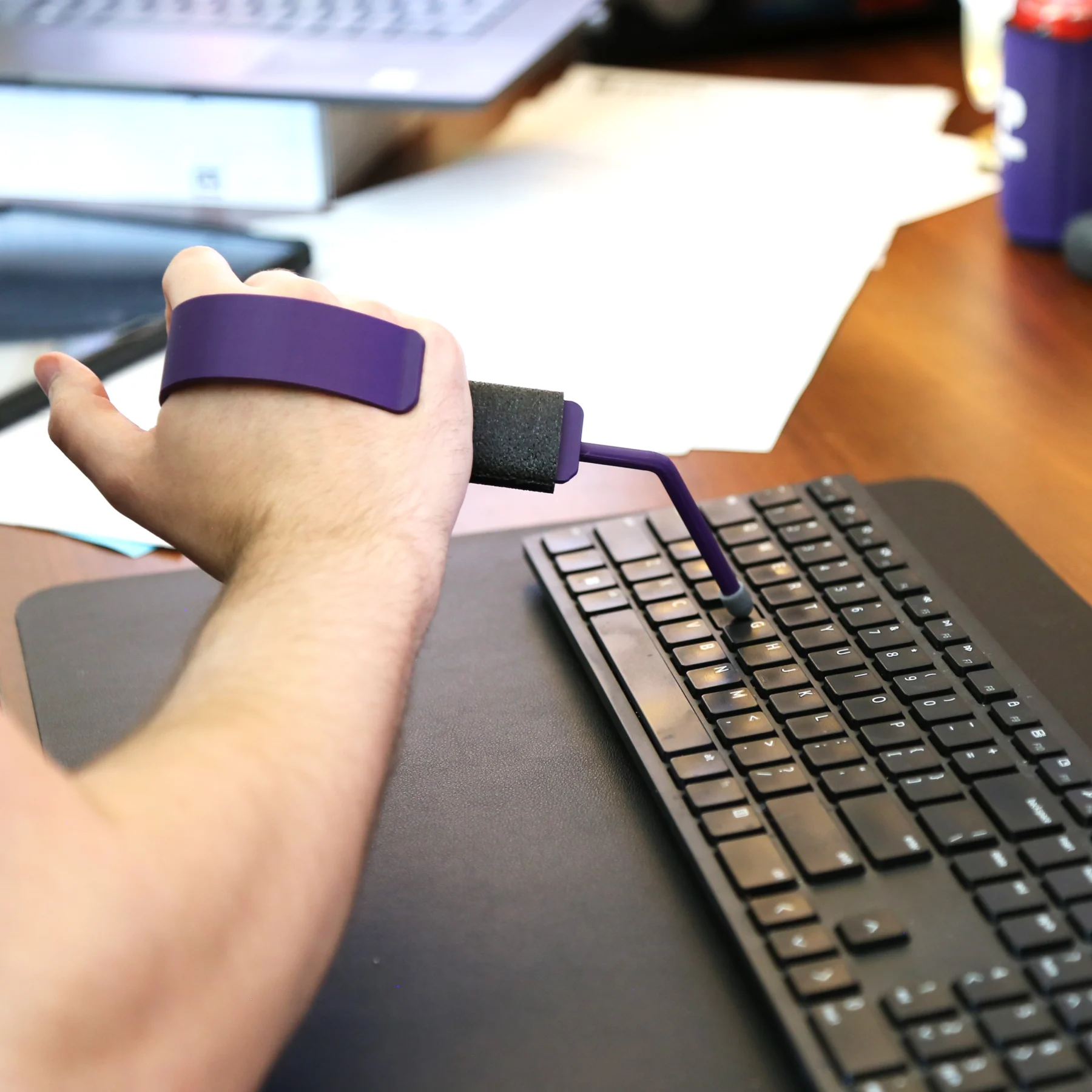 1.1 Person using typing sticks on keyboard