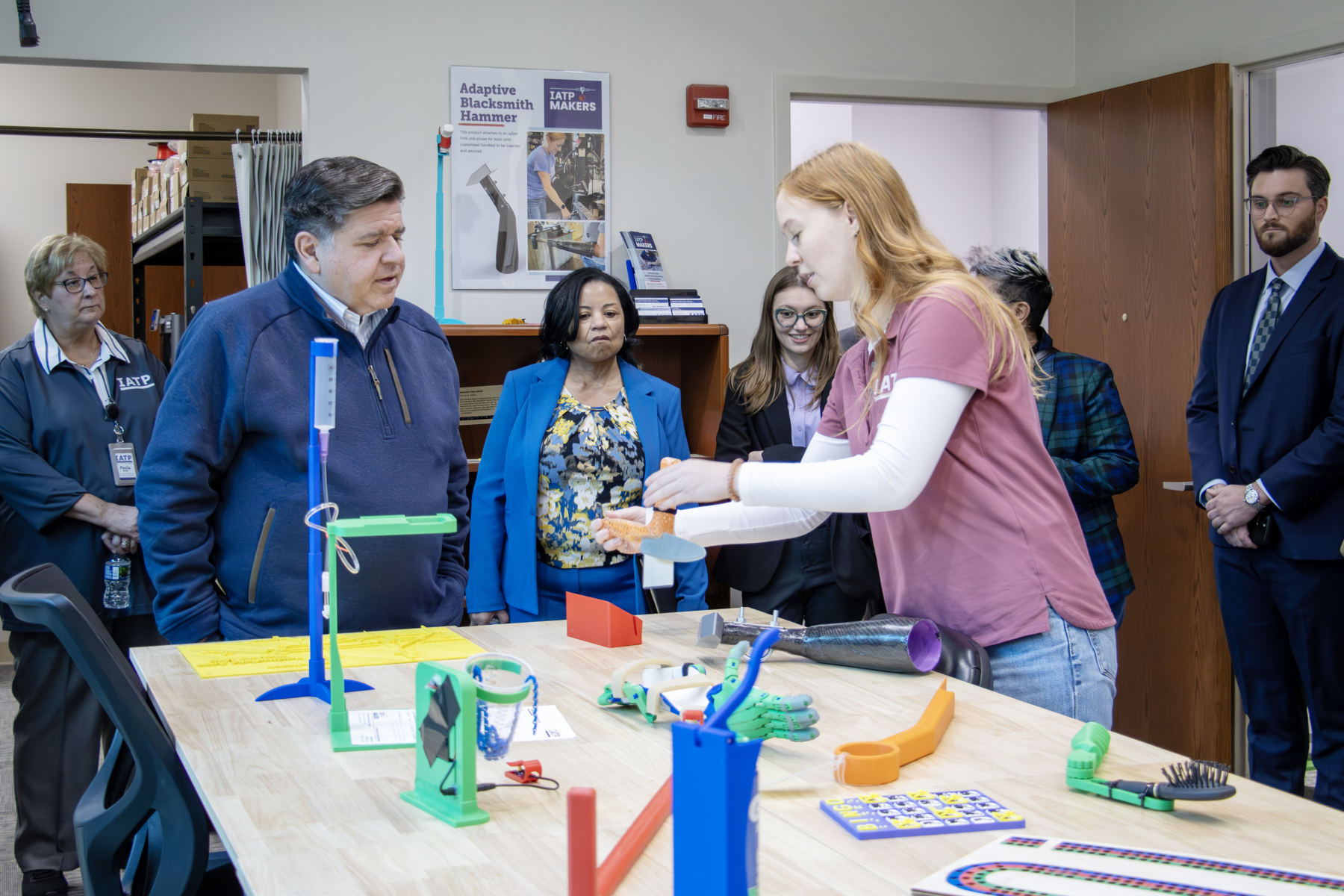 IATP Maker staff showing Governor Pritzker custom fabricated assistive technology