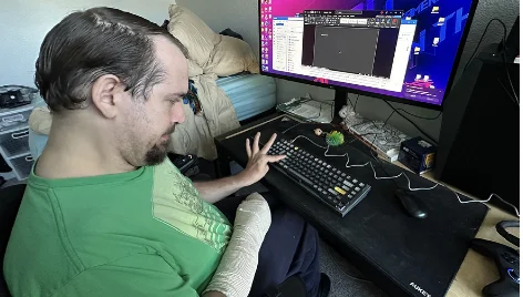 Alex using his keyguard to operate his computer
