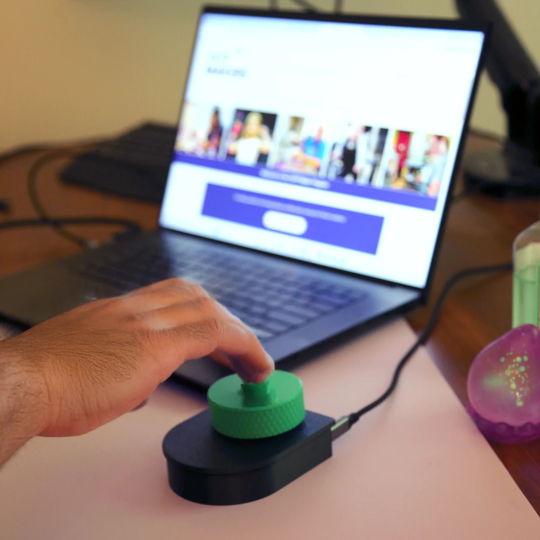 The Enlarged Scroll Wheel being used with a laptop with a man controlling it The Enlarged Scroll Wheel being used with a laptop with a man controlling it