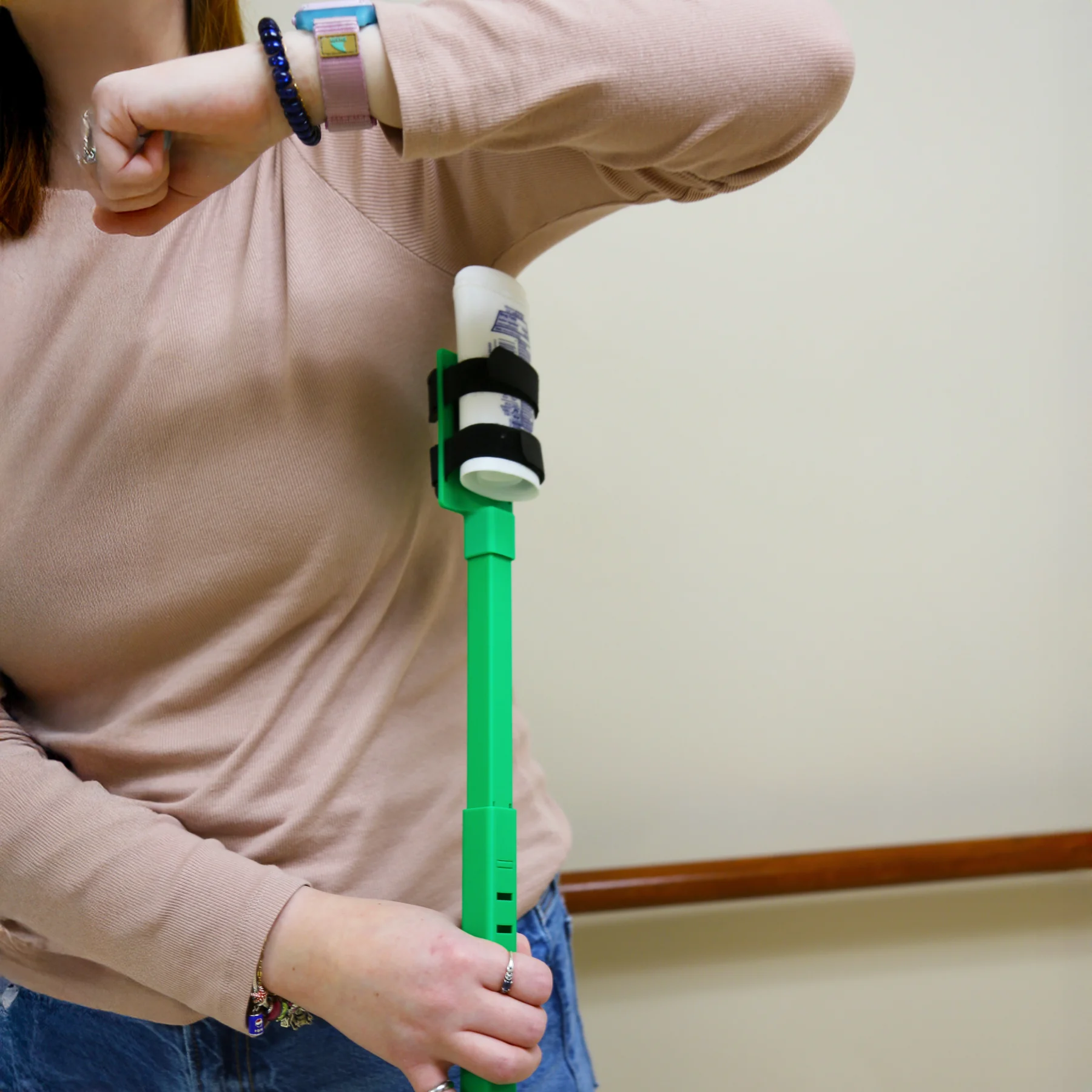 A woman demonstrating how to use the antiperspirant extender.
