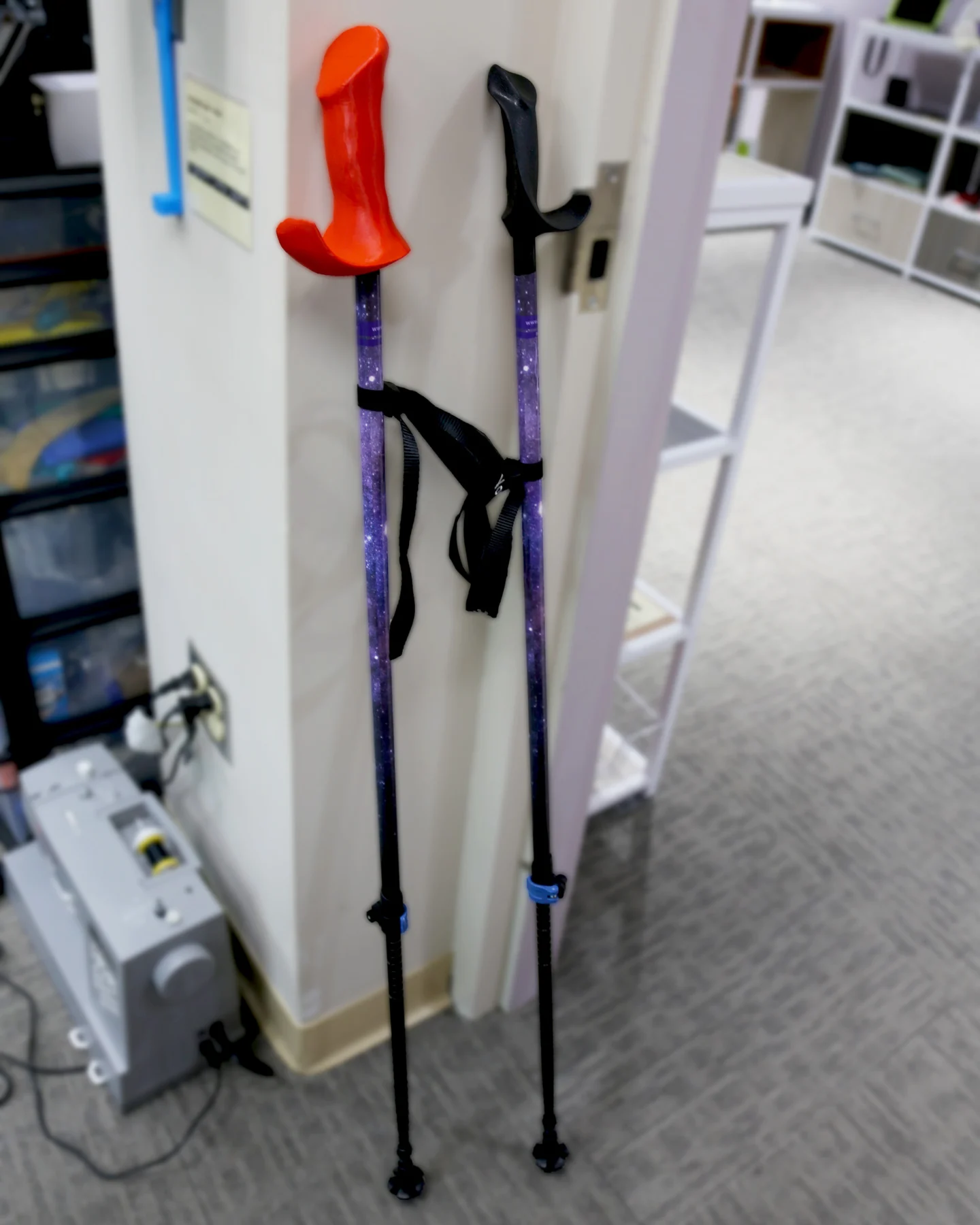 Walking sticks with the new produced red handle vs the standard handle resting against a wall. Walking sticks with the new produced red handle vs the standard handle resting against a wall.