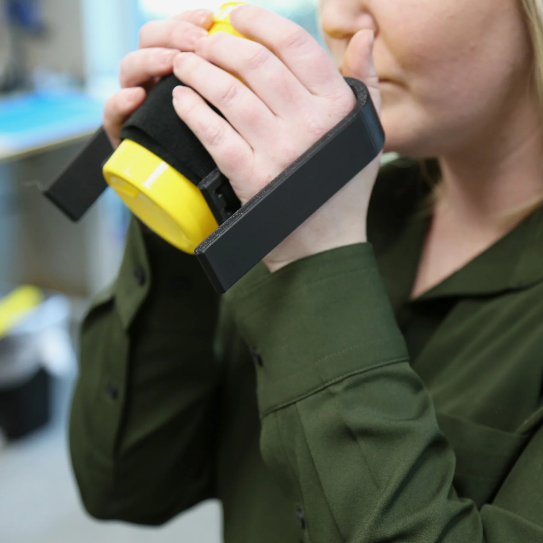 Woman using universal cup handles bringing the cup to mouth