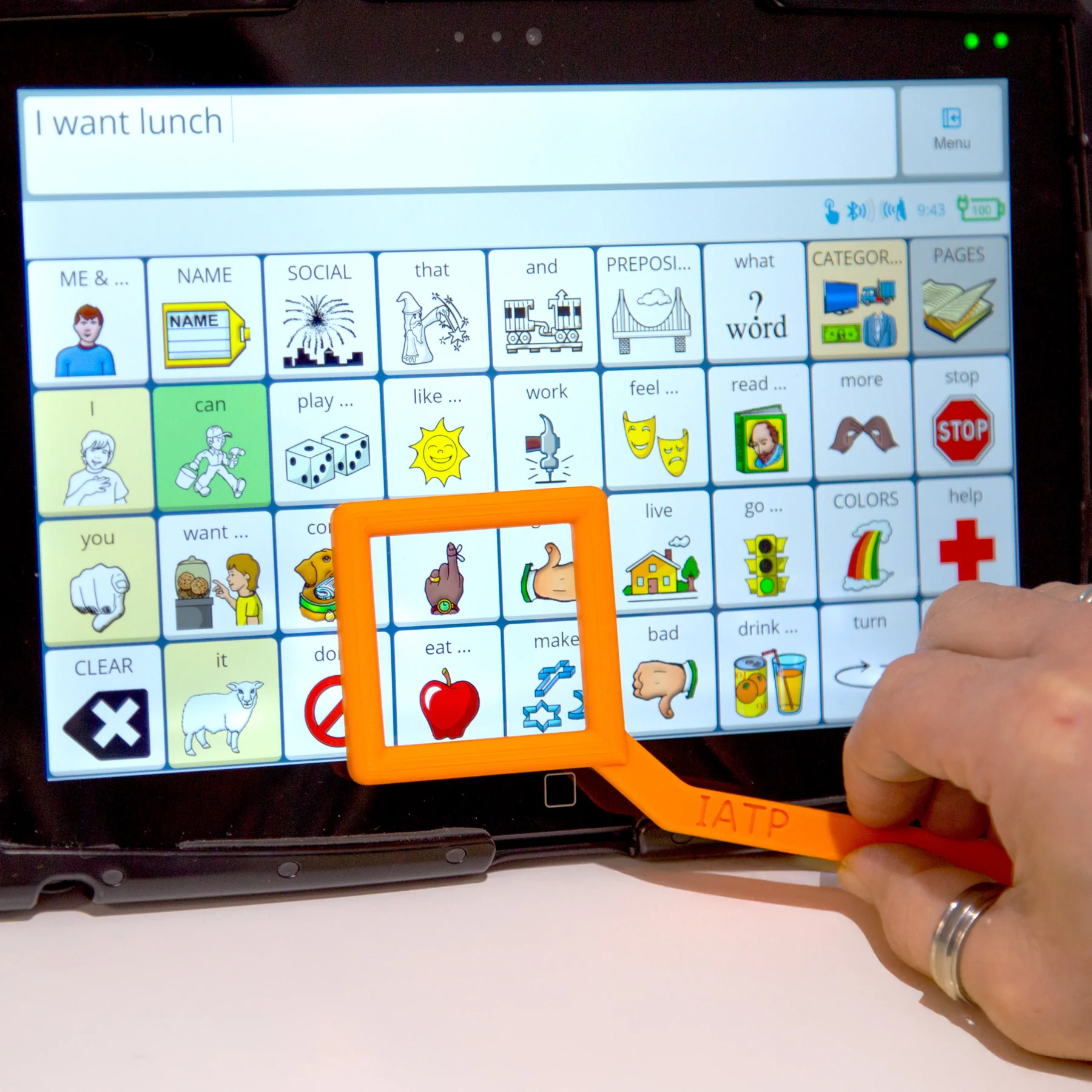An AAC device with the text 'I want lunch' with the visual prompting aid, prompting someone to push the eating related response.