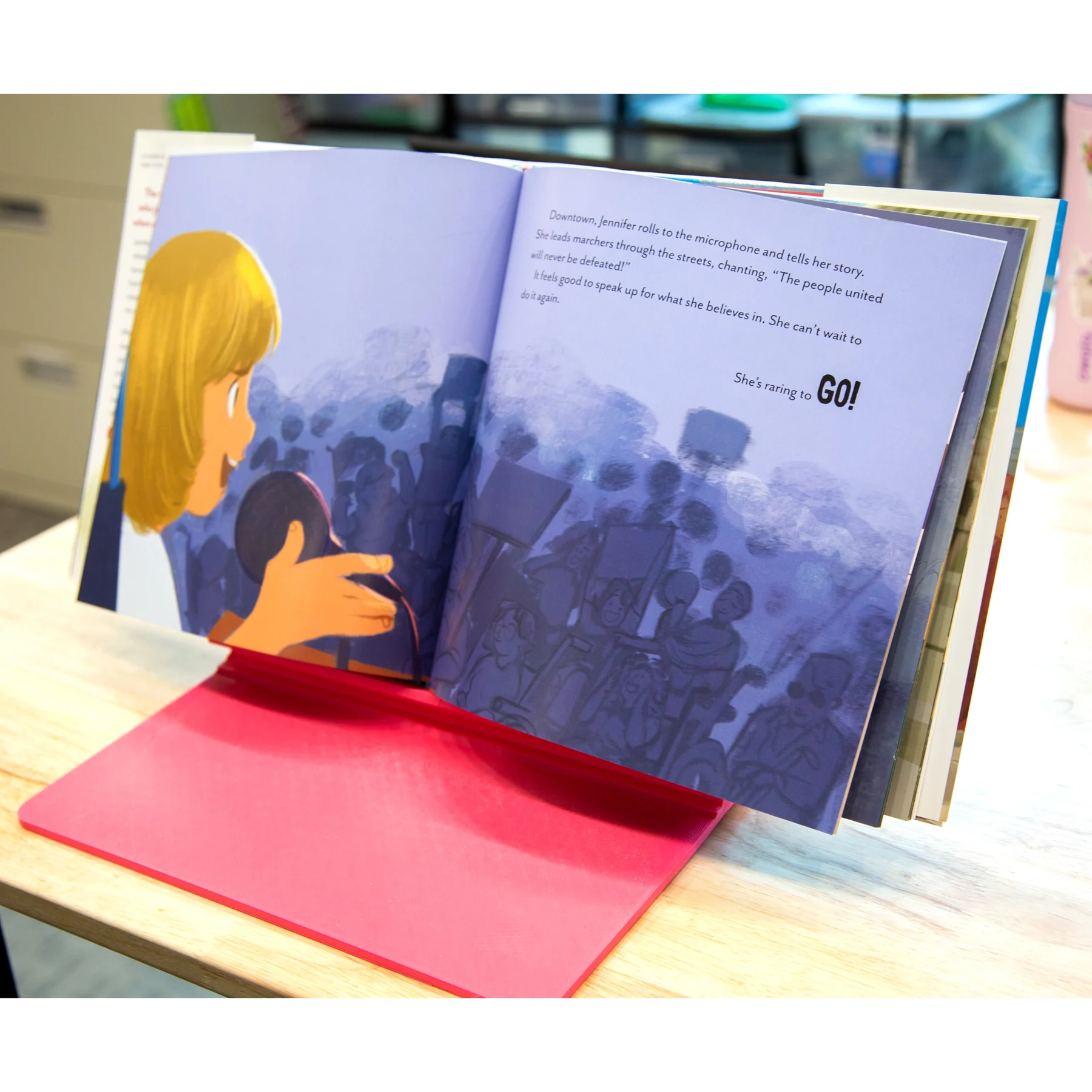 Adjustable Slant Board resting on a table with an opened children's book, the book All the way to the top by Annette Bay Pimentel