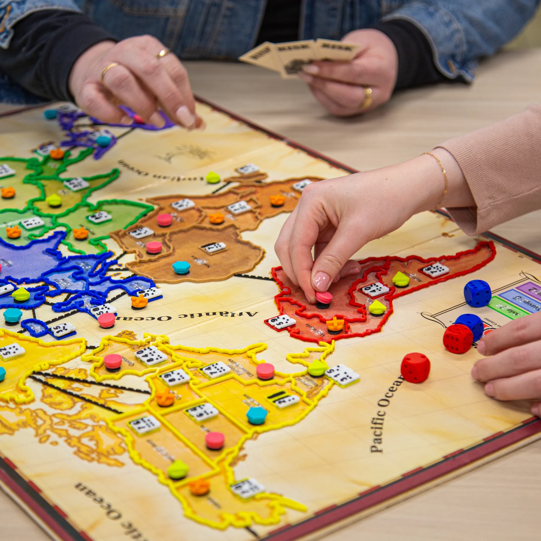 Adapted Risk board Person placing a pink circle into the red territory