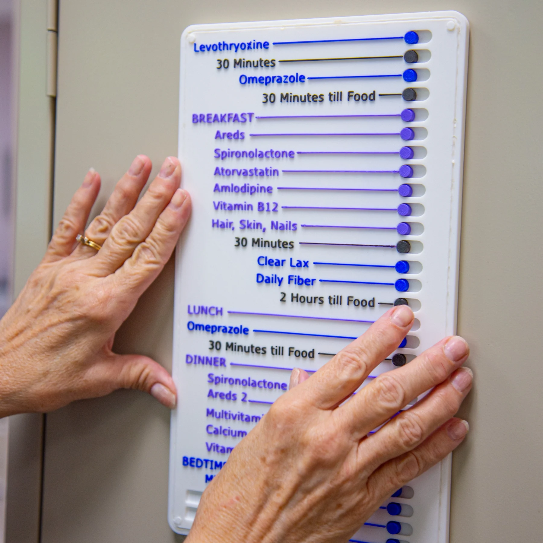 Elderly woman using the pill map