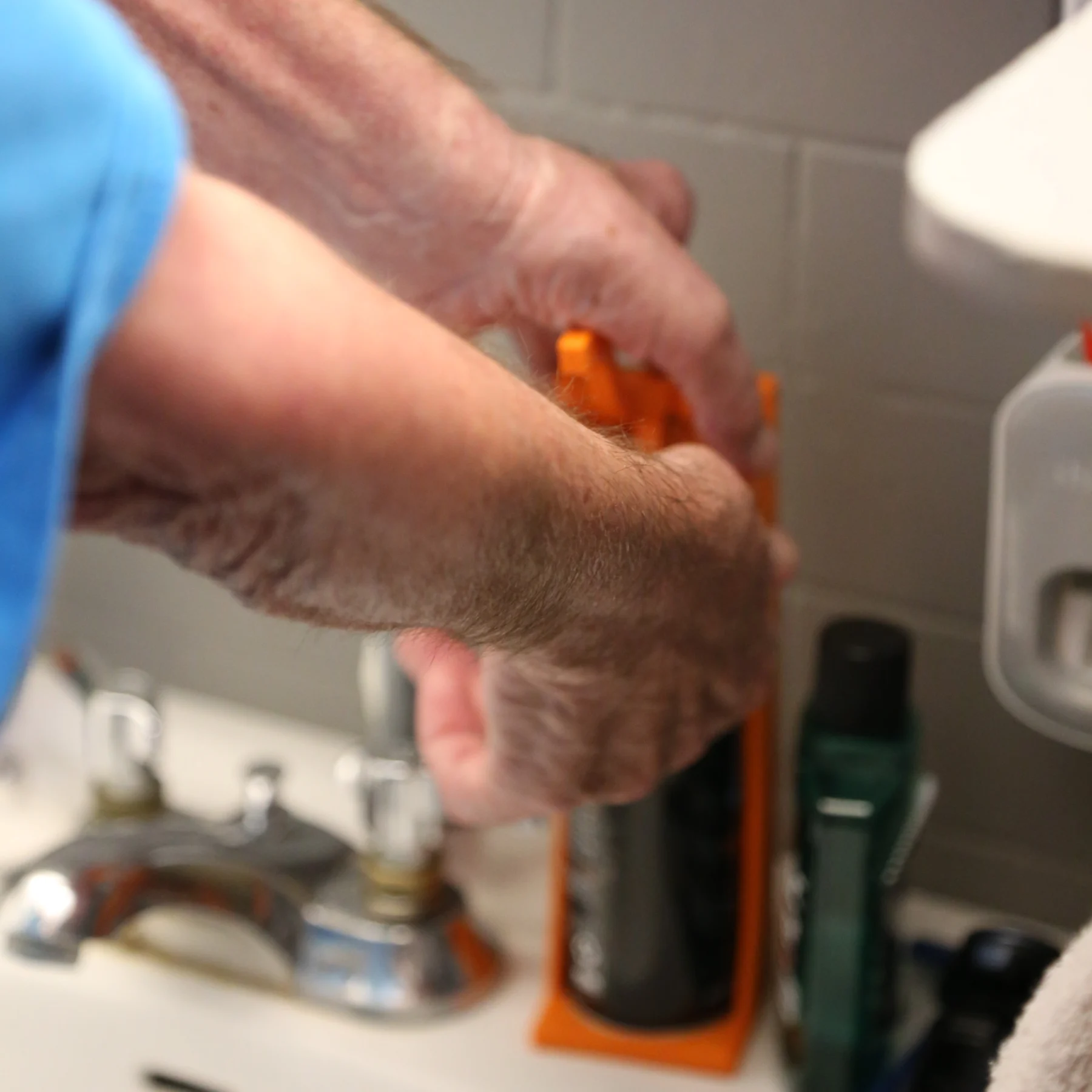 Shaving cream dispenser Elder man catching shaving cream into his hand