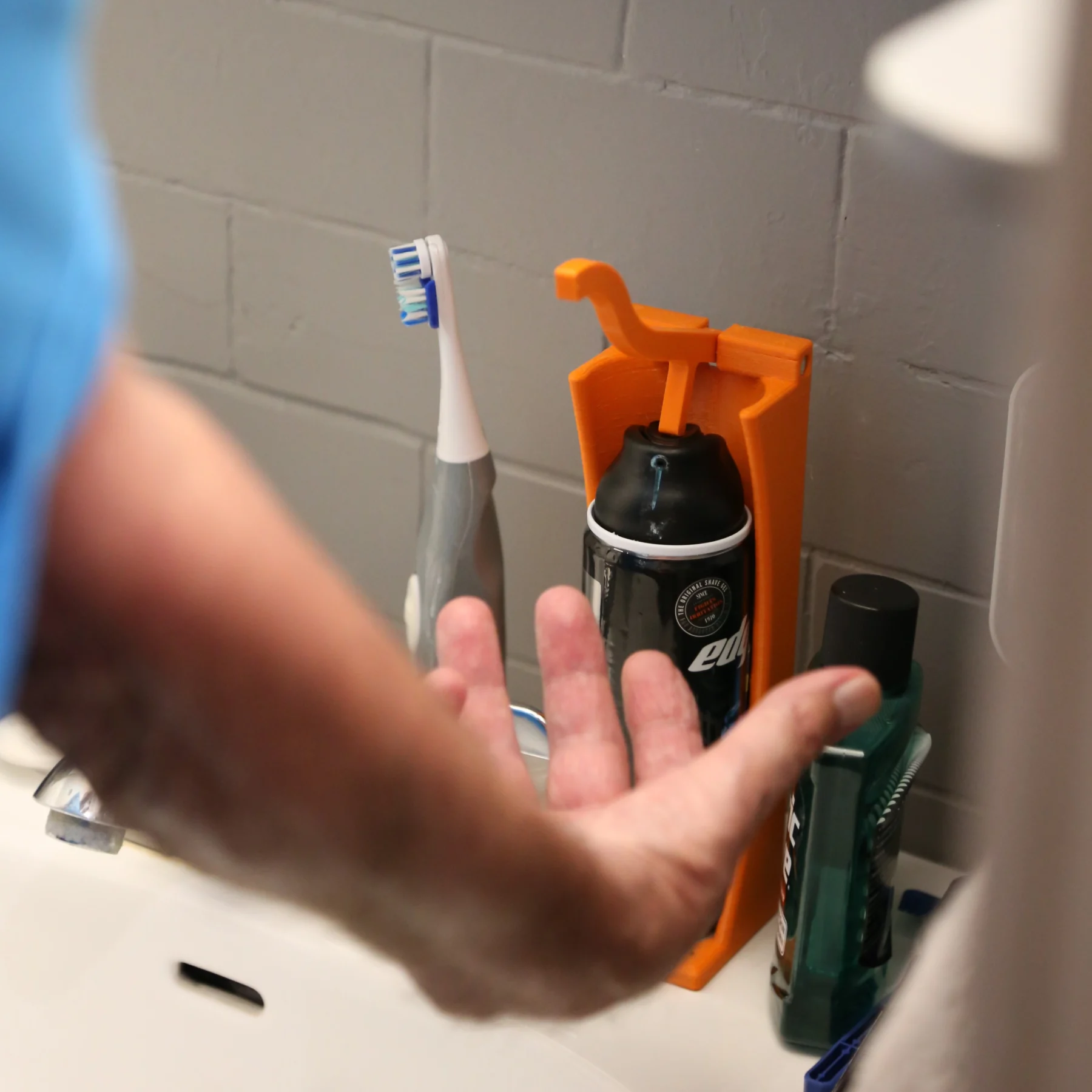 Shaving cream dispenser Elder man catching shaving cream into his hand after pressing down on it