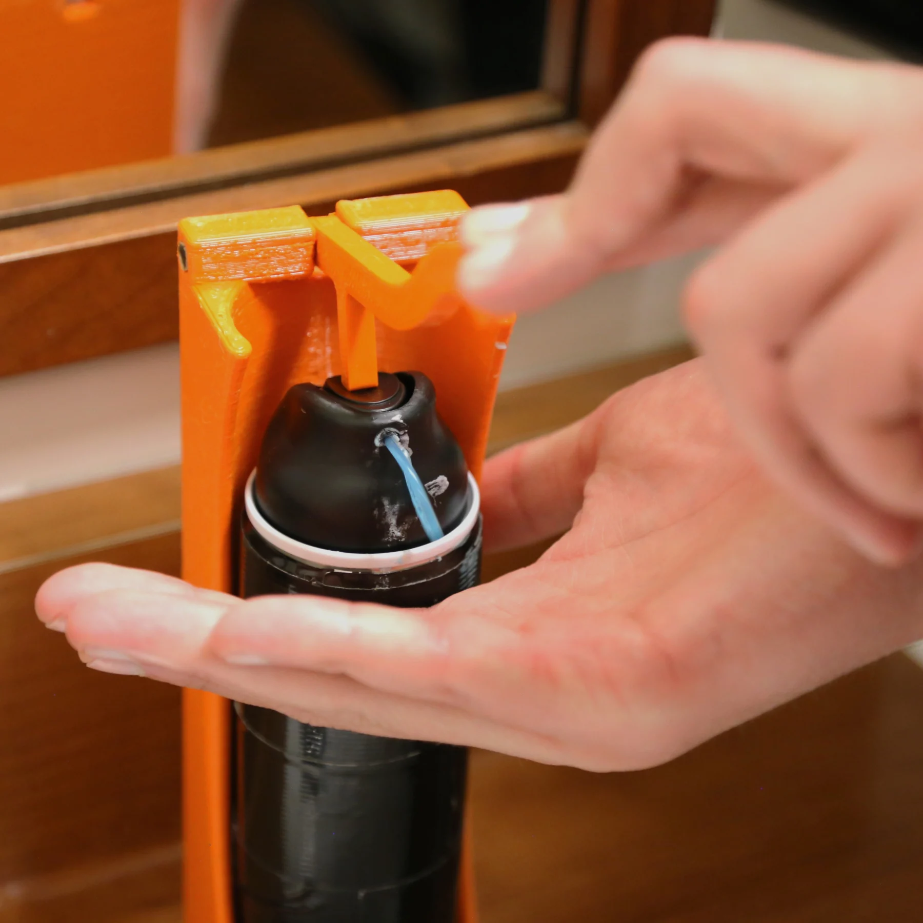 Shaving cream dispenser someone pressing down on the shaving cream assist releasing shaving cream onto their hand