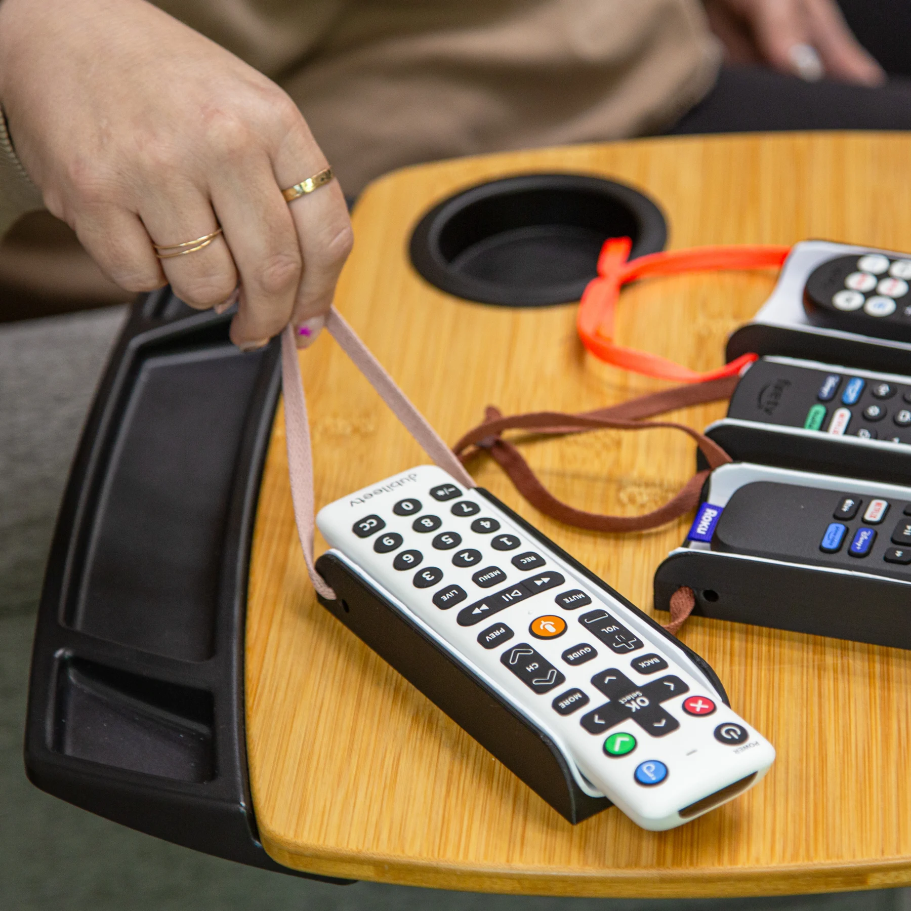 Someone pulling the string attached to the Remote Control Sleeve to pull it closer to them