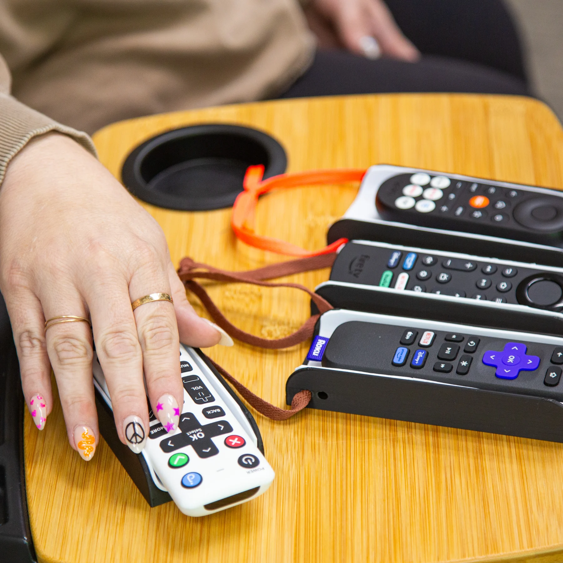 Someone pressing remote buttons while resting in remote control sleeve