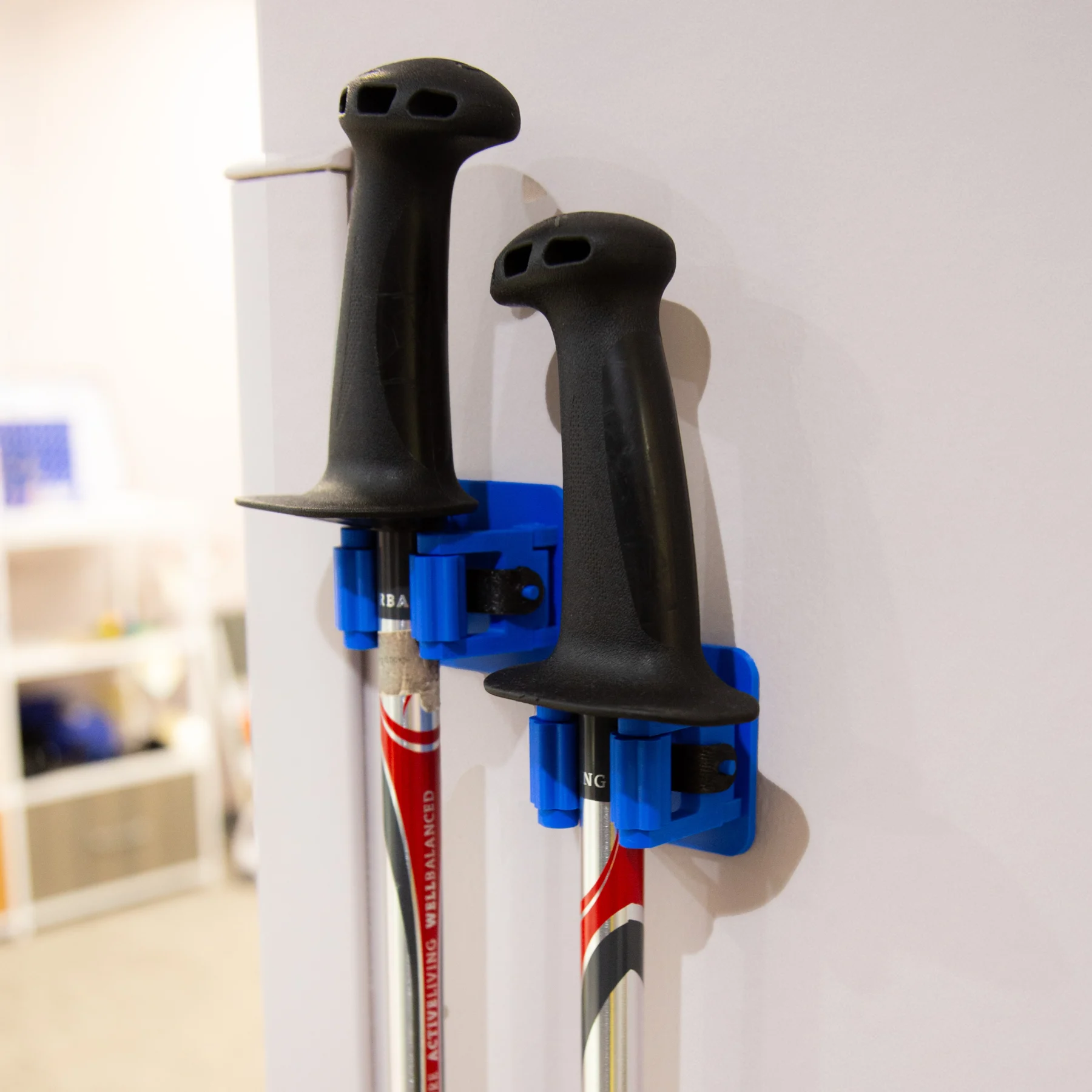 2 Cane holders on a wall holding walking sticks