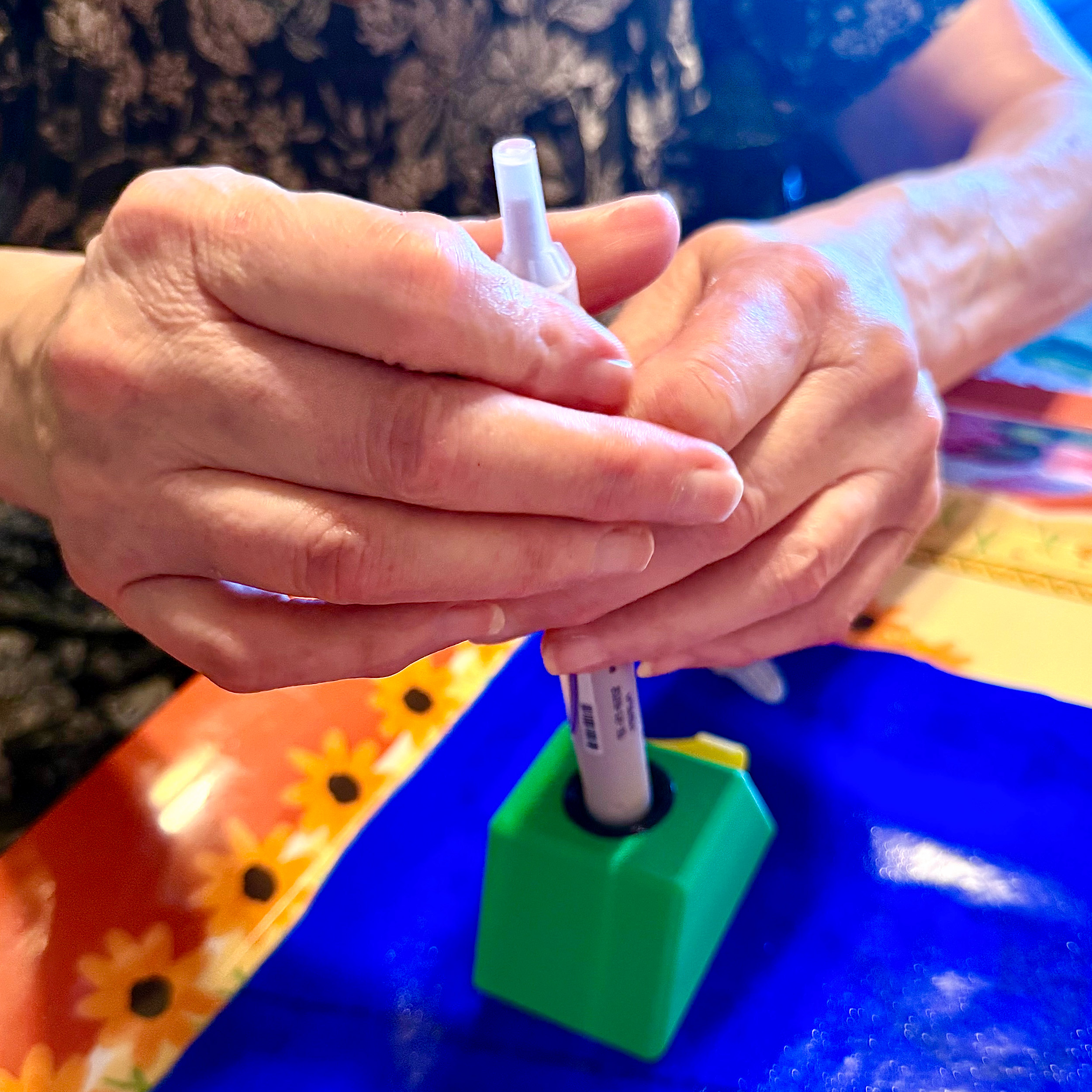 Christine using Insulin Pen Stabilizer Block to be able to open her pen Christine using Insulin Pen Stabilizer Block to be able to open her pen